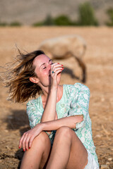 Happy woman enjoying wind in field