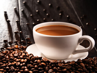 Composition with cup of coffee and beans