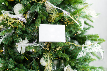 Christmas composition. Paper form on the branches of a Christmas tree. Copy space, square