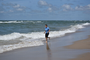 a woman runs happily on the beach