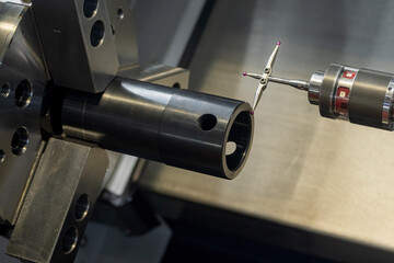 Close up scene the modular touch probe checking the tube parts on CNC lathe machine.