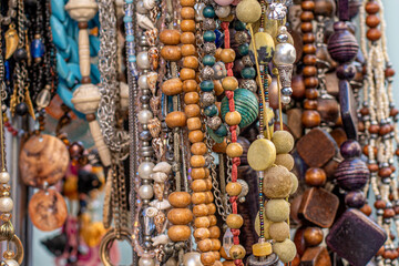 Beads and necklaces made of colored semi precious stones. Background from a variety of beautiful...