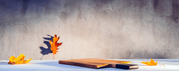 Cutting board with product place or copy space with fallen autumn leaves on it