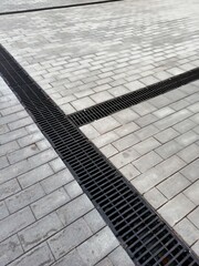 
Drain, street drainage on paving stones.
