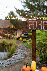 A wooden signbourd with lantern for the sale of autumn harvest at the fair