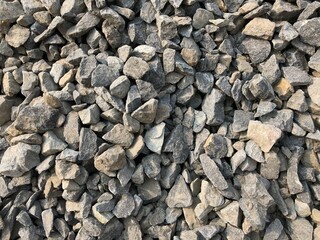 Closeup of granite stone ballast. Black color stones texture art background.