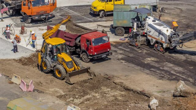 Aerial view of large road construction site with several industrial machines timelapse. Earthmoving equipment and asphalt milling machine