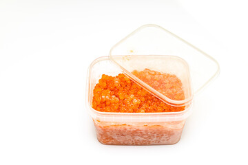 red caviar in a plastic container on a white background