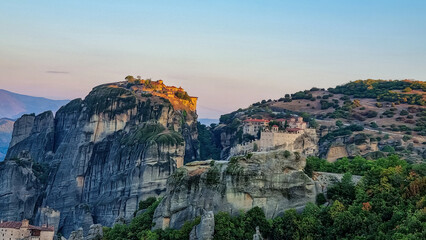 Scenic sunrise view of Holy Monastery of Great Meteoron and Holy Monastery of Varlaam near Kalambaka, Meteora, Thessaly, Greece, Europe. Dramatic landscape. Orthodox landmark build on rock formations
