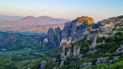 Fototapeta premium Early morning aerial panoramic view during sunrise of the monasteries of Meteora (Great Meteoron, Varlaam, Rousanou, Nicholas Anapafsas, Holy Trinity) in Kalambaka, Meteora, Thessaly, Greece, Europe