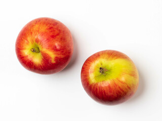 Two of whole apples, top view on white background.