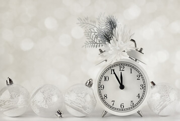 Christmas monochrome composition with festive decorations and alarm clock on holiday background