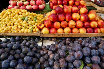 Colorful stone fruit on sale at local farmers market.