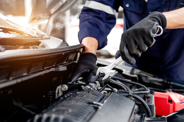 Car care maintenance and servicing, Close-up hand technician auto mechanic using the wrench to repairing change spare part car engine problem and insurance service support.