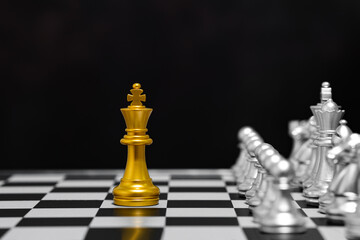 Chess Single king stand alone against many enemies as a symbol of difficult unequal fight or struggle of minorities confidence concept.