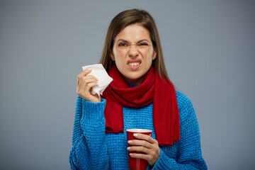 Sick woman touching hand holding white napkin and red mug. isolated portrait
