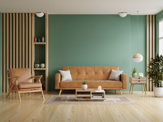 Living room with leather sofa and leather armchair on empty dark green wall background.