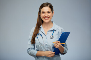 Smiling doctor woman holding clipboard. Isolated portrait of female medical worker