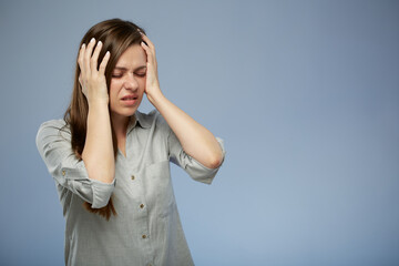 Young woman with headache touching head. isolated female portrait with eyes closed.