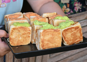 Close up view of Bread with pandan filling in a black tray