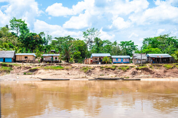shanty village at peruvian amazon riverbank