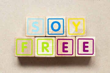 Color letter block in word soy free on wood background