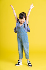 full body image of beautiful asian baby girl on yellow background