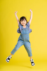 full body image of beautiful asian baby girl on yellow background