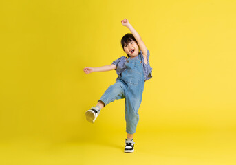 full body image of beautiful asian baby girl on yellow background - Powered by Adobe
