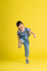Fototapeta na wymiar full body image of beautiful asian baby girl on yellow background