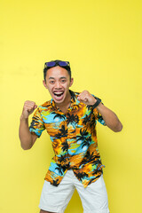 a man wearing a beach shirt and white pants