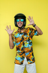 a man wearing a beach shirt and white pants