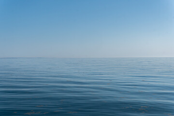 Fototapeta premium Beautiful and calm blue sea and sky, tranquility. Warm sunny day on beach. 