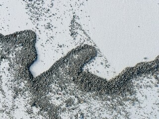 福徳岡ノ場からの軽石が白い砂浜に描く模様