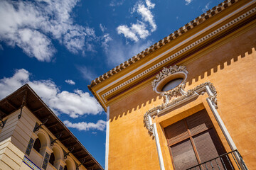 Fototapeta na wymiar Colorful facades of the old town of Mula, in Murcia, Spain with the intense blue sky in the background