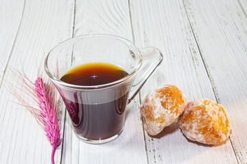 Cup of coffee on woody background.