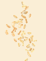 Flying raw oatmeal on light background