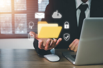 Document Management System DMS .Businessman hold folder and document icon on office desk, Virtual online documentation database and process automation to efficiently manage files.