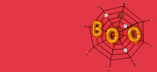 Word BOO made of balloons and Halloween decor on red background with space for text