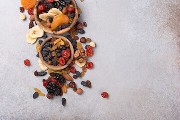Wooden bowls with raisins, nuts and other dried fruit, berries as ingredient for tasty dessert