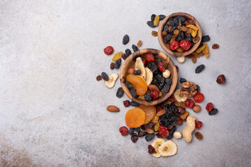 Wooden bowls with raisins, nuts and other dried fruit, berries as ingredient for tasty dessert