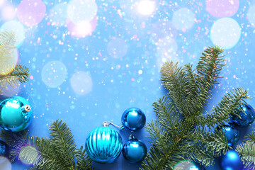 Fototapeta na wymiar Beautiful Christmas balls and fir tree branches on blue background