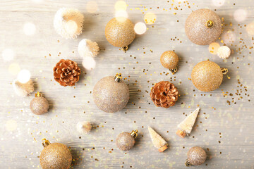 Beautiful Christmas decorations and coniferous cones on grey wooden background