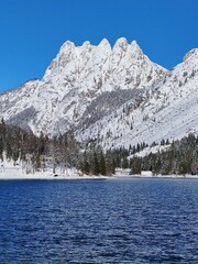 Snow covered mountains of Cinque Punte at Lake Predil in Julian Alps