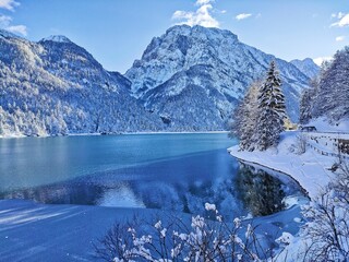 winter landscape with snow covered mountains at lake Predil on Julian Alps