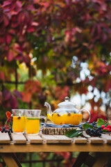 Food photography autumn sea buckthorn tea in a transparent teapot