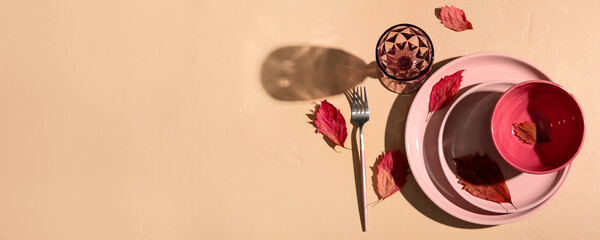 Autumn table setting on beige background with space for text