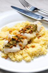 cod with green pesto and pine seeds with couscous