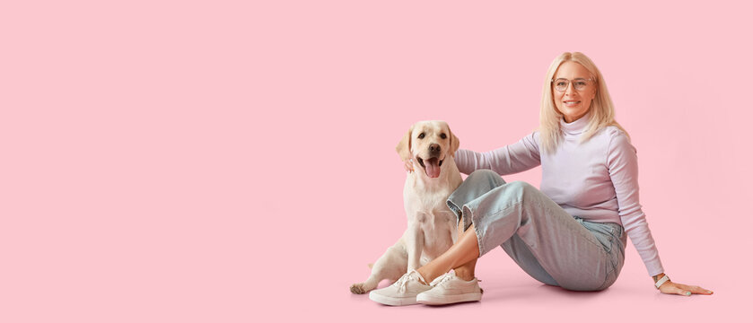 Mature Woman With Cute Labrador Dog On Pink Background With Space For Text