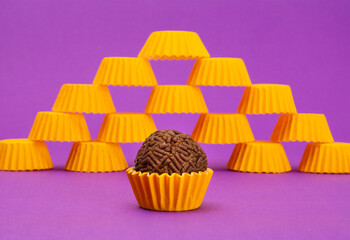 Brigadeiros, tradicional Brazilian sweet, on purple background, yellow packaging